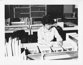 Photograph of an unidentified person looking at files in the Killam Library