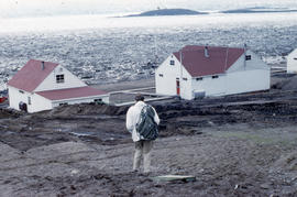 Photograph of Barbara Hinds and two houses in Frobisher Bay, Northwest Territories