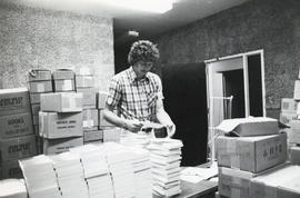 Photograph of John Cassidy unpacking books