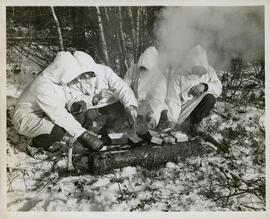Photograph of four unidentified soldiers cooking during winter infantry training at Debert