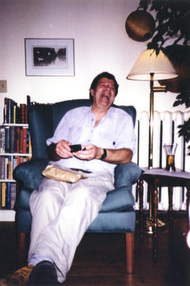 Photograph of Bill Owen seated in armchair at his farewell party