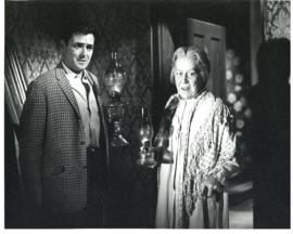 Photograph of "Neil" (James Doohan) and "Grandmother Jamieson" (Jane Mallett) in a hall at night,...