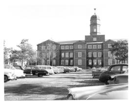 Photograph of the Arts and Administration building and campus parking lot
