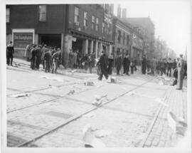 Photograph of dispersing crowds and detritus on Hollis Street after the Halifax VE-Day riots