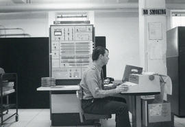 Photograph of man using a computer