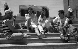 Photograph of students sitting on the steps by the Killam Library