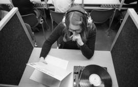 Photograph of a student listening to a record