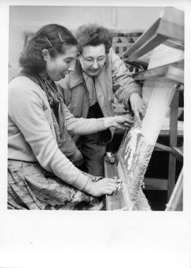Photograph of two unidentified women working at a loom