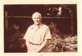 Portrait of Thomas Head Raddall in his garden in the summer