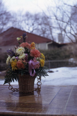 Photograph of multicolored flowers in a wicker pot