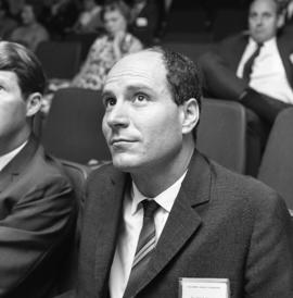 Photograph of an unidentified person in an auditorium