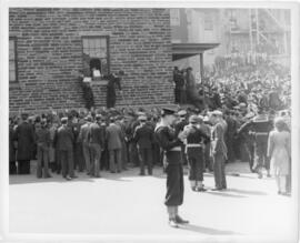 Photograph of sailors looting beer through a broken window at Keith's Brewery during the Halifax ...
