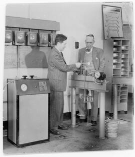 Photograph of G.G. Meyerhof and a client in the Geotechnical Soil Testing Lab at Nova Scotia Tech...