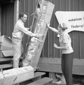 Photograph of Doreen and Collingwood Wynne moving a box at Wakeham Bay, Quebec