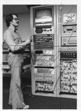 Photograph of Douglas Barrett adjusting a patchboard