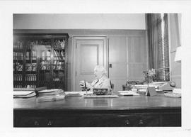 Photograph of Henry Hicks sitting at a desk