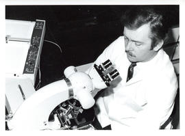 Photograph of individual using a microscope