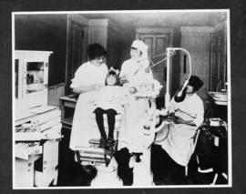 Photograph of Dr. Arrabelle MacKenzie with assistants at a dental clinic