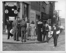 Photograph of men carrying looted shoes on the corner of Blowers Street and Granville Street duri...
