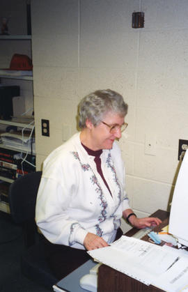 Photograph of Patricia Lutley working at a computer in the Killam Memorial Library