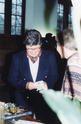 Photograph of Sylvia Fullerton opening a gift at her retirement party
