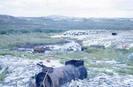 Photograph of several barrels on the tundra
