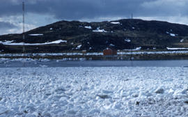 Photograph of ice floes and a building in Frobisher Bay