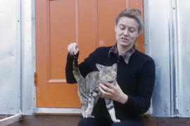 Photograph of Barbara Hinds petting a cat in Frobisher Bay, Northwest Territories
