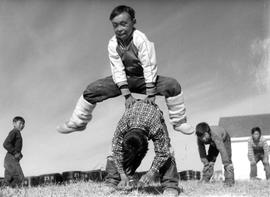 Photograph of children playing leap frog in Cape Dorset, Northwest Territories