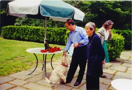 Photograph of Elisabeth Mann Borgese, a dog, and two unidentified people