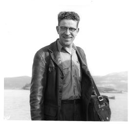 Photograph of an unidentified man with glasses and a leather jacket