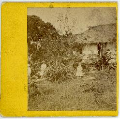Photograph of three unidentified children standing in front of Dayspring Cottage, in Aneityum, Ne...