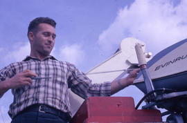 Photograph of a man operating an outboard motor in Newfoundland and Labrador