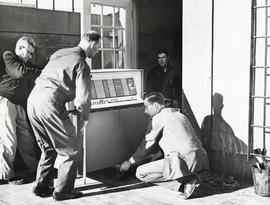 Photograph of men moving computer equipment into the Sir James Dunn Science Building