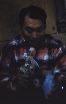 Photograph of an unidentified man with a small axe