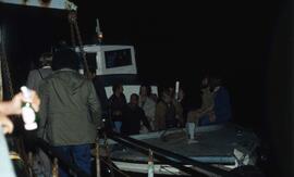 Photographic negative of people on a boat