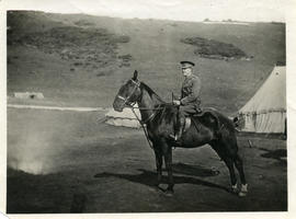 Soldier on horse in front of tents