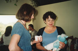 Photograph of Donna Kenney and Mary Anne Long at a group baby shower held in the staff room of th...