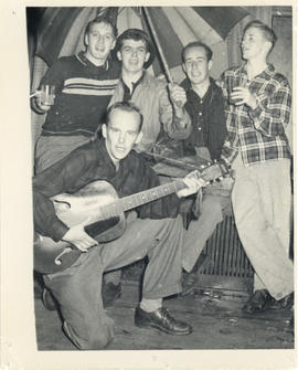 Photograph of five students with a guitar, umbrella, and drinks