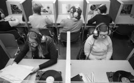 Photograph of a students listening to records and tapes