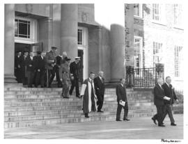 Photograph of a procession leaving the Sir James Dunn Building