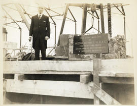 Hector McInnes next to the cornerstone plaque