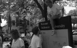 Photograph of a student on the Dalhousie welcome sign