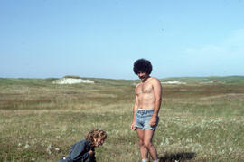 Photograph of Bill Freedman and one unidentified person standing in the grassy plain on Sable Island