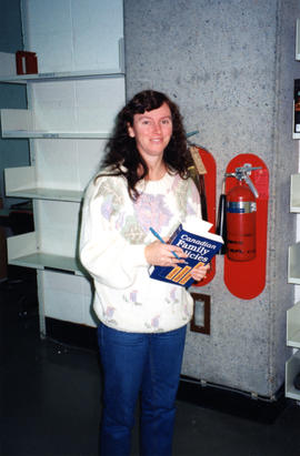 Photograph of Nancy Melvin in the Circulation Department of the Killam Memorial Library