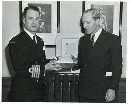 Photograph of Chief of Naval Staff Harry DeWolfe making a presentation to Angus L. Macdonald upon...