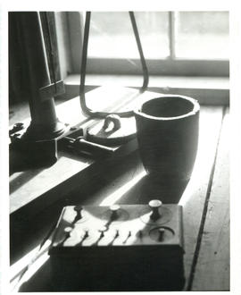 Photograph of a crucible beside a gold-weighing scale and weights at the Whiteburn mine