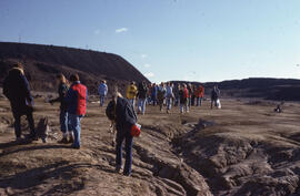 Photograph of a group of researchers standing near slag heaps at the Coniston site, near Sudbury,...
