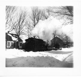 Photograph of the Liverpool-Milton train on Main Street near the old Cobb house