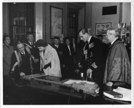 Photograph of Dr. Kerr showing a document to Princess Elizabeth